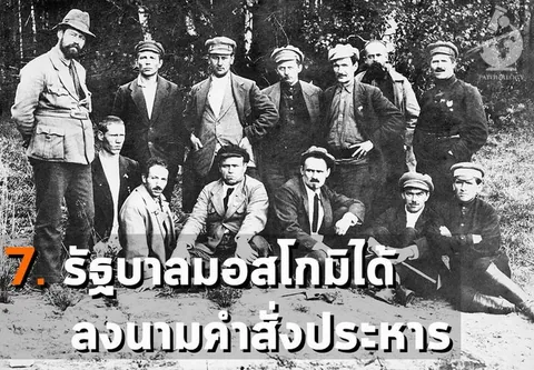 ภาพถ่ายขาวดำกลุ่มชายประมาณสิบสามคนในชุดยุคเก่า นั่งและยืนเป็นแถวหน้าต้นไม้ พร้อมข้อความไทยทับที่ด้านล่าง