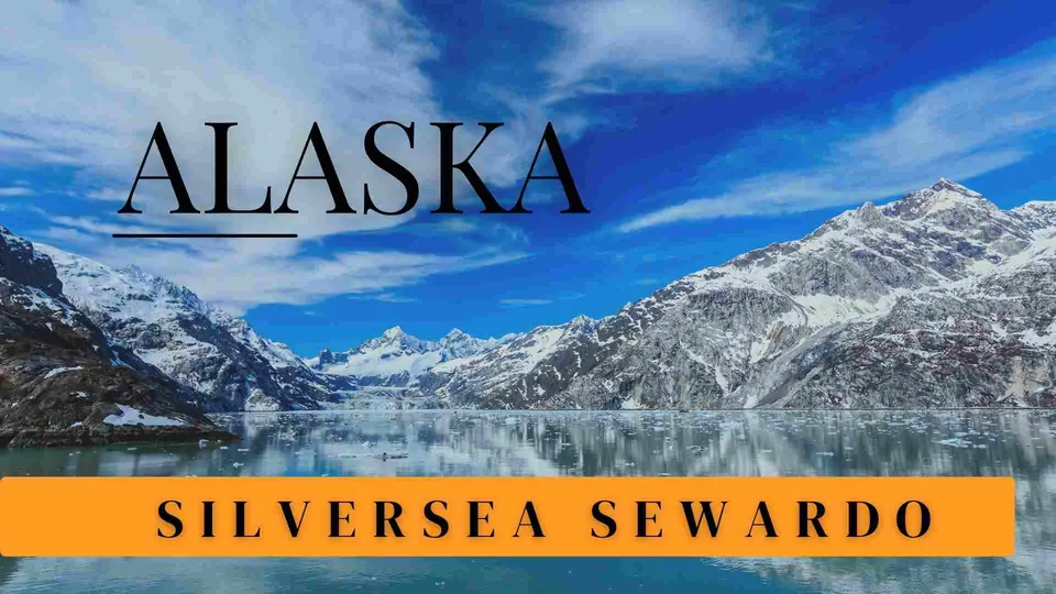 ทิวทัศน์ภูเขาหิมะสะท้อนบนผิวน้ำ มีข้อความ ALASKA และแถบสีส้มเขียนว่า SILVERSEA SEWARD